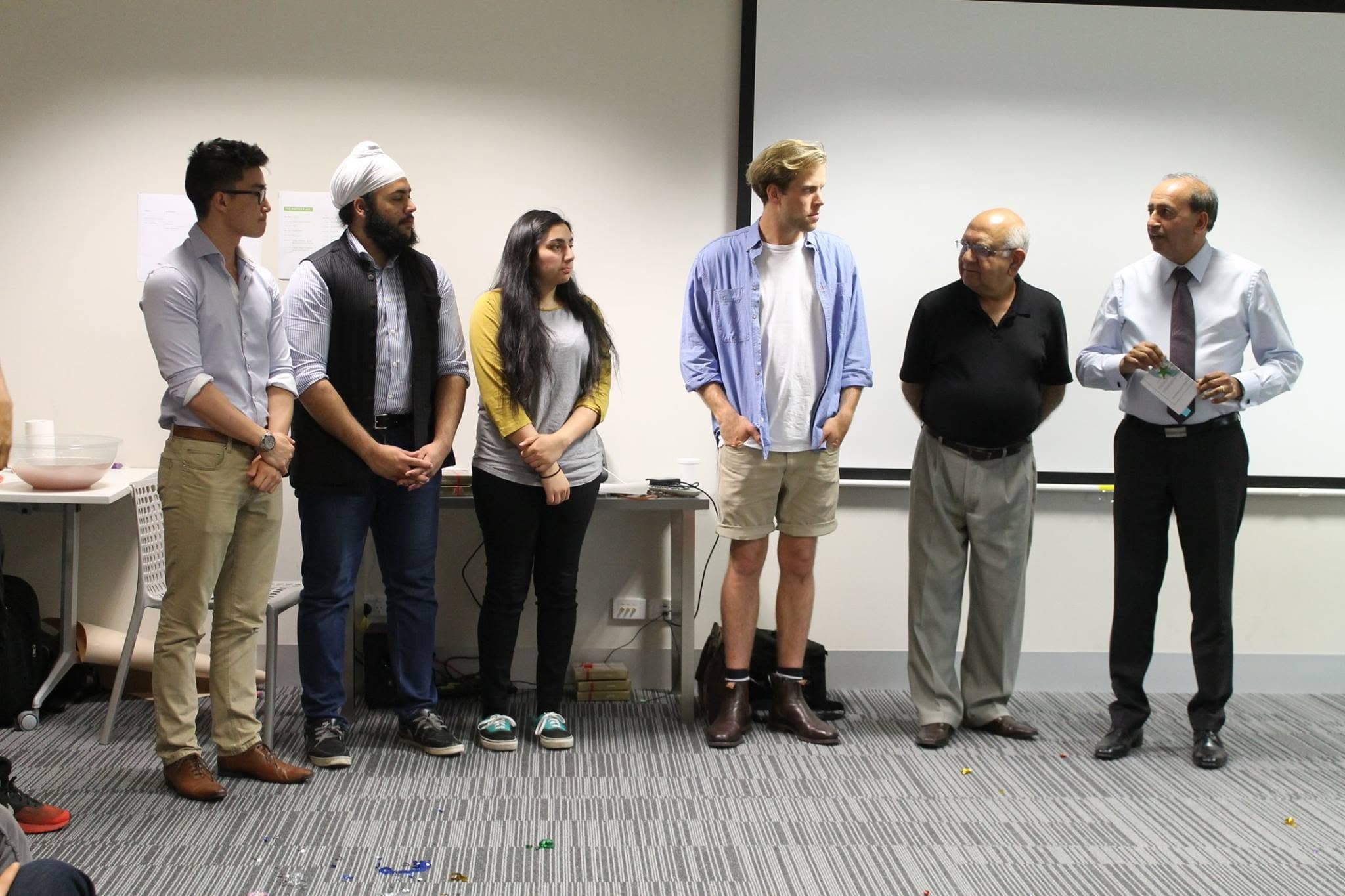 Melbourne's winning team with the judges